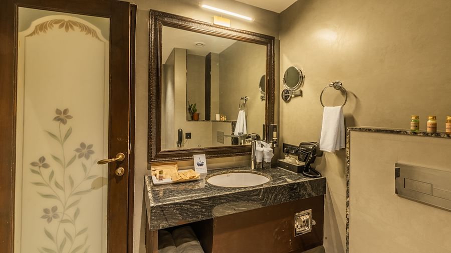 an image of a side view of a bathroom with toiletries and a cabinet.